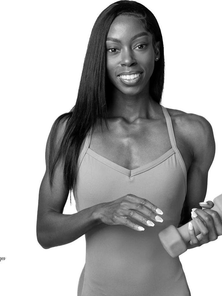 Black and white fitness portrait with a dumbbell