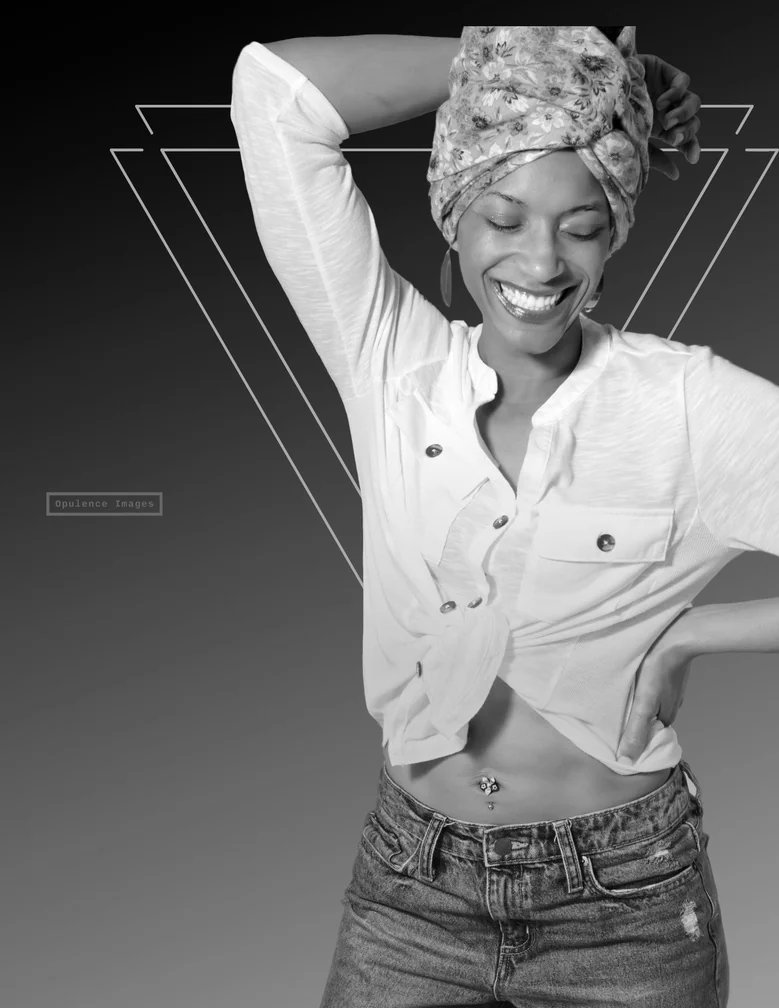 Smiling woman in a patterned headwrap and white shirt