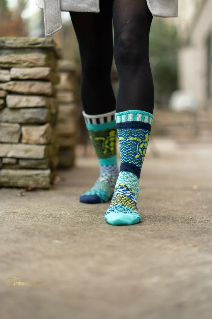 Colorful patterned socks on an outdoor walkway