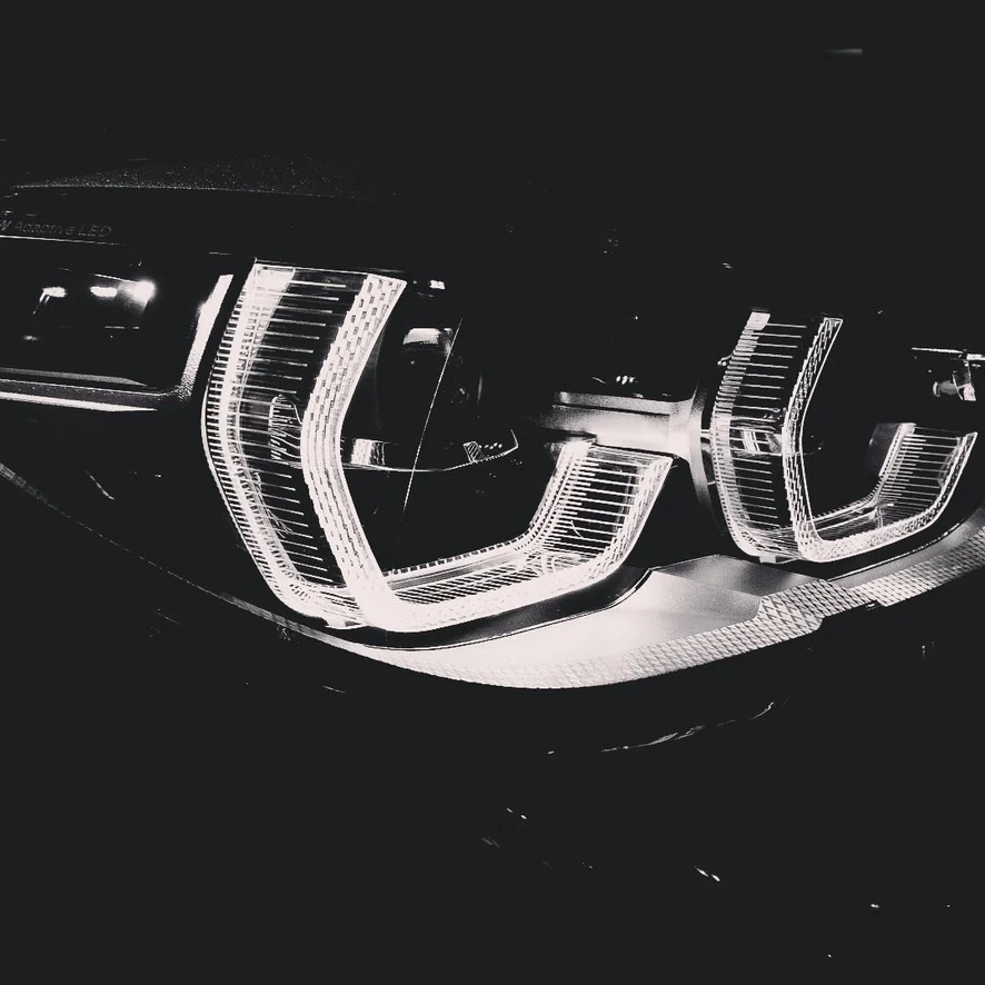 Black and white close-up of car headlights